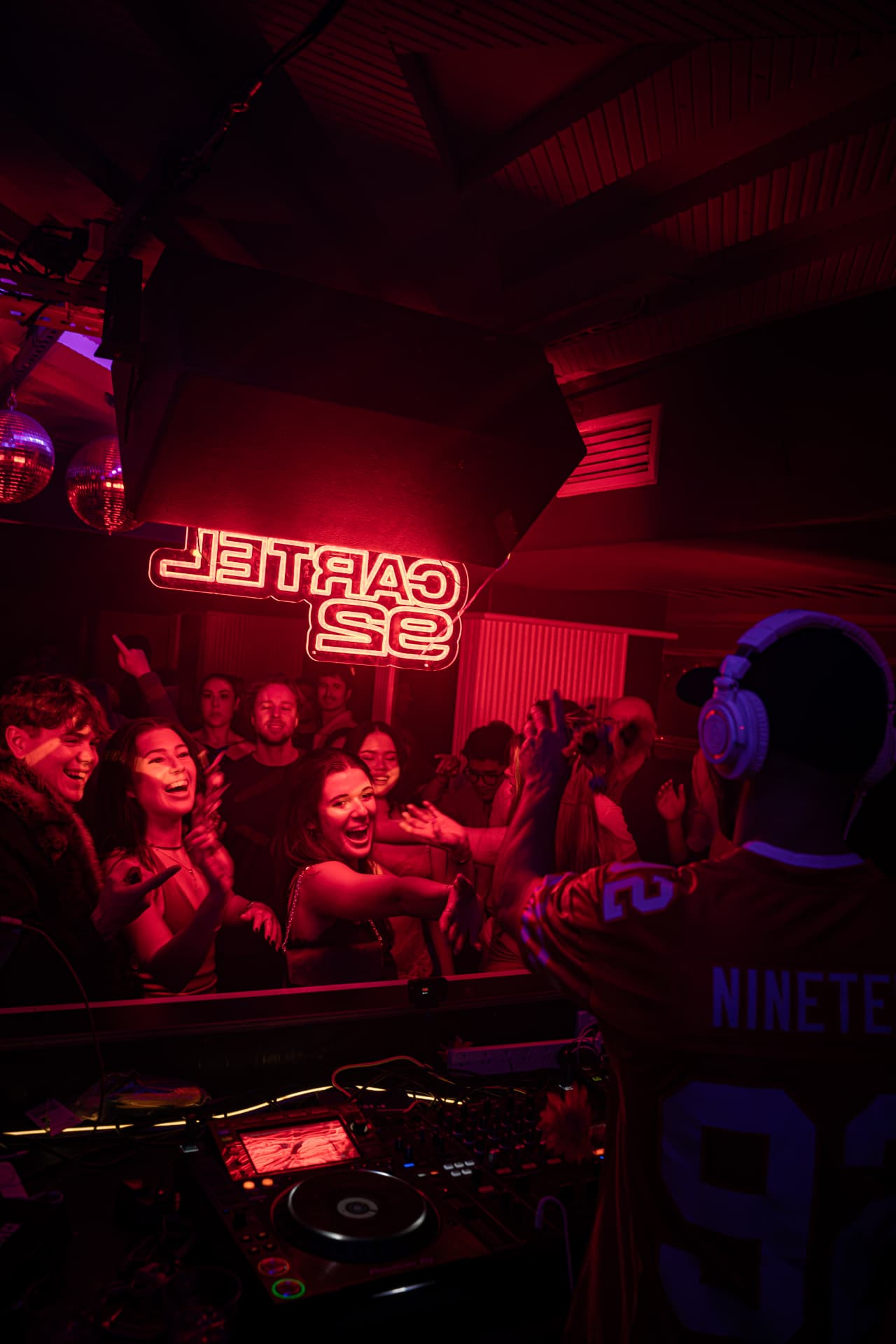 NINETEEN92 MUSIC DJ set under neon lights